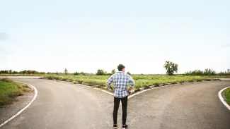 Man at a crossroads deciding which path to take