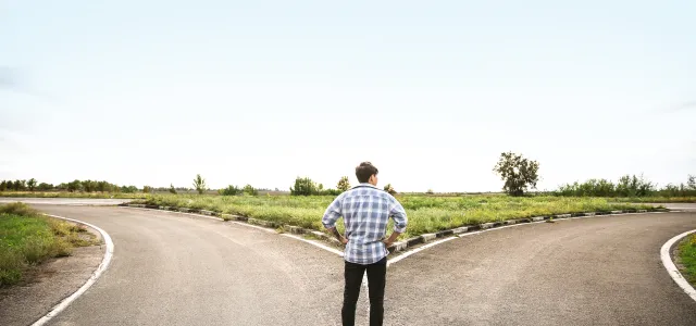 Man at a crossroads deciding which path to take